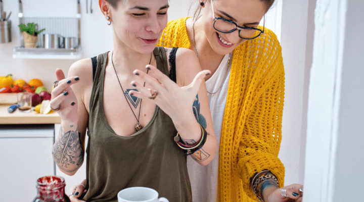 lesbian couple cooking dinner discussing estate plan