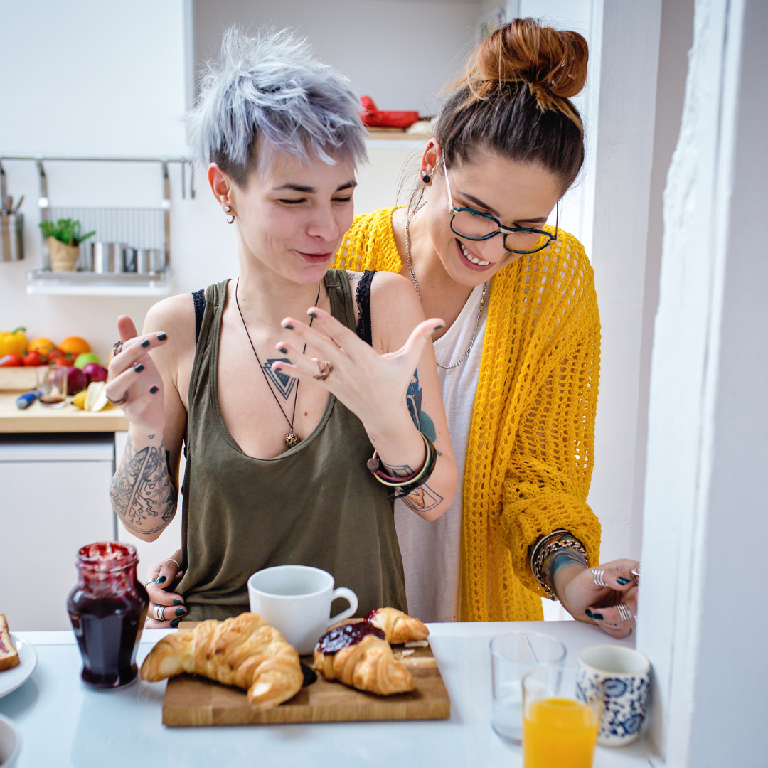 lesbian couple cooking dinner discussing estate plan